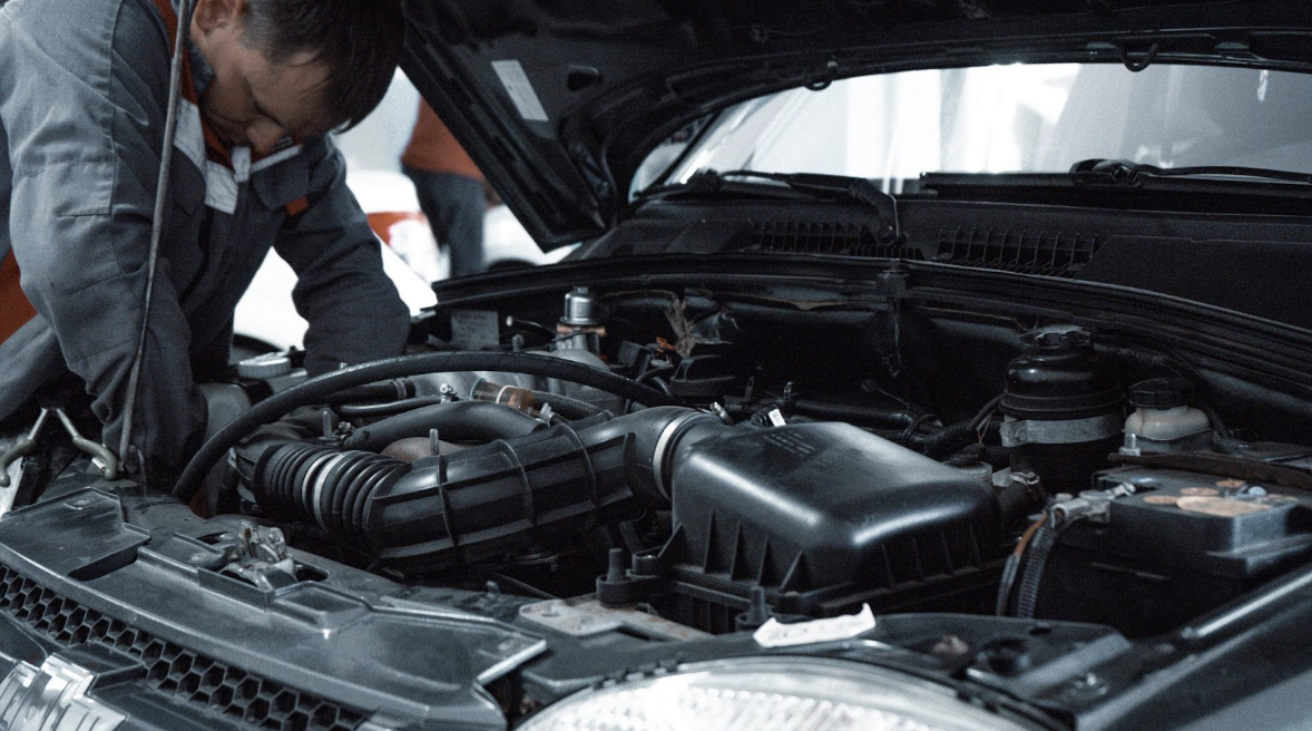 Man performing maintenance and repair on vehicle