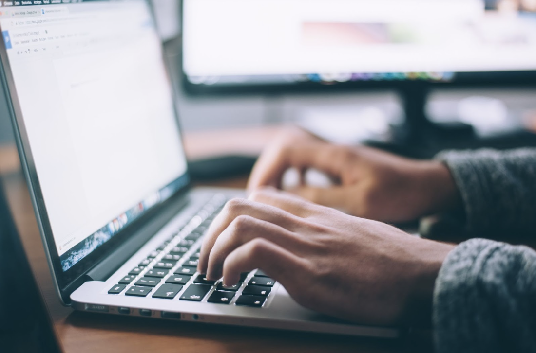 person searching on laptop for answers to trading in car