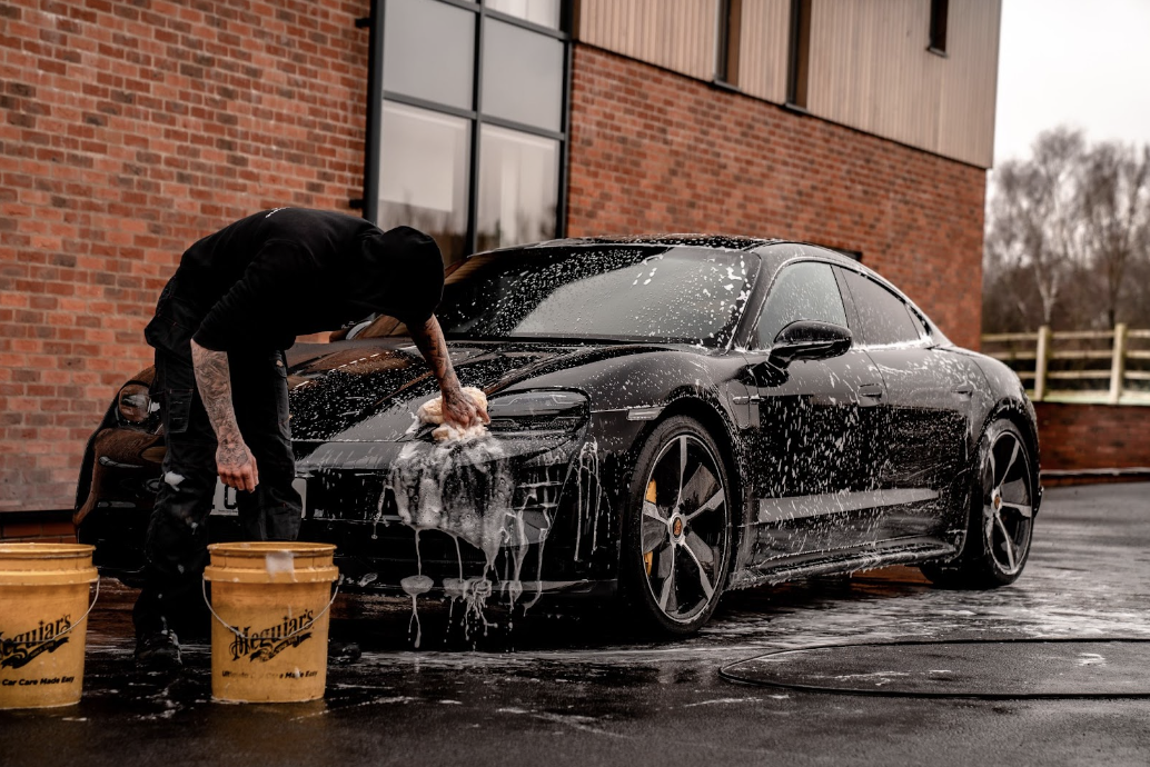 man washing car getting ready to trade in
