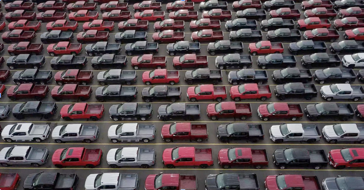 parking lot with rows of trucks