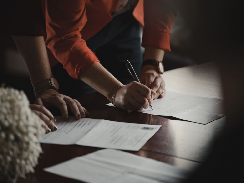 person filling out car loan paperwork