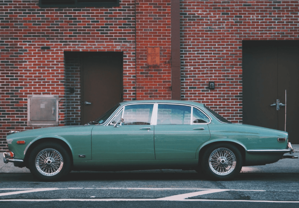 older used vehicle parked on the street