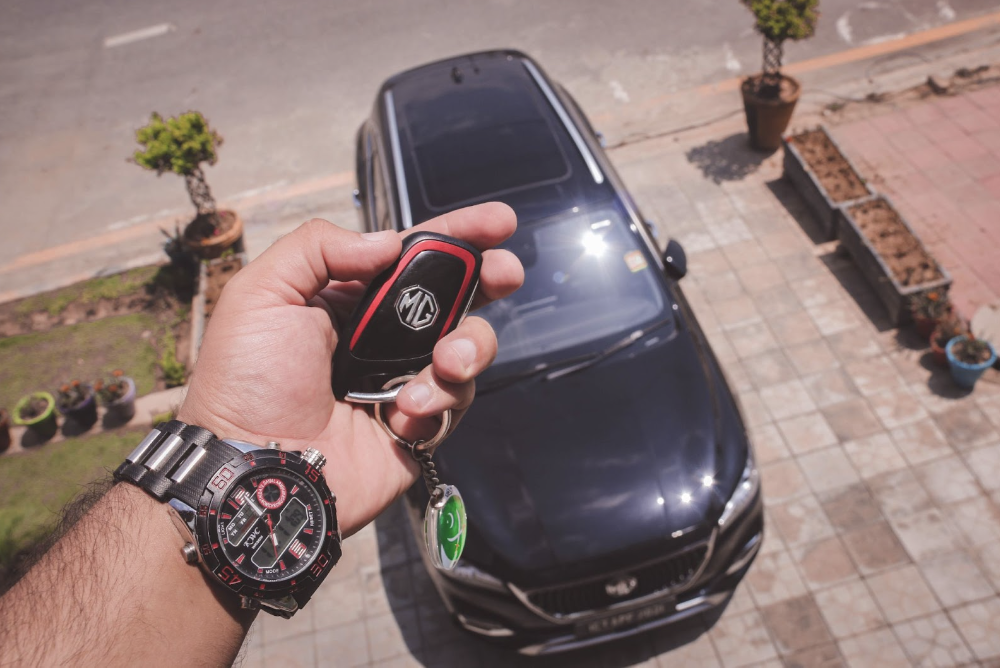 person holding keys to used car ready to sell or trade in