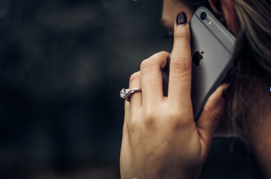 woman on phone getting appraisal for car trade in