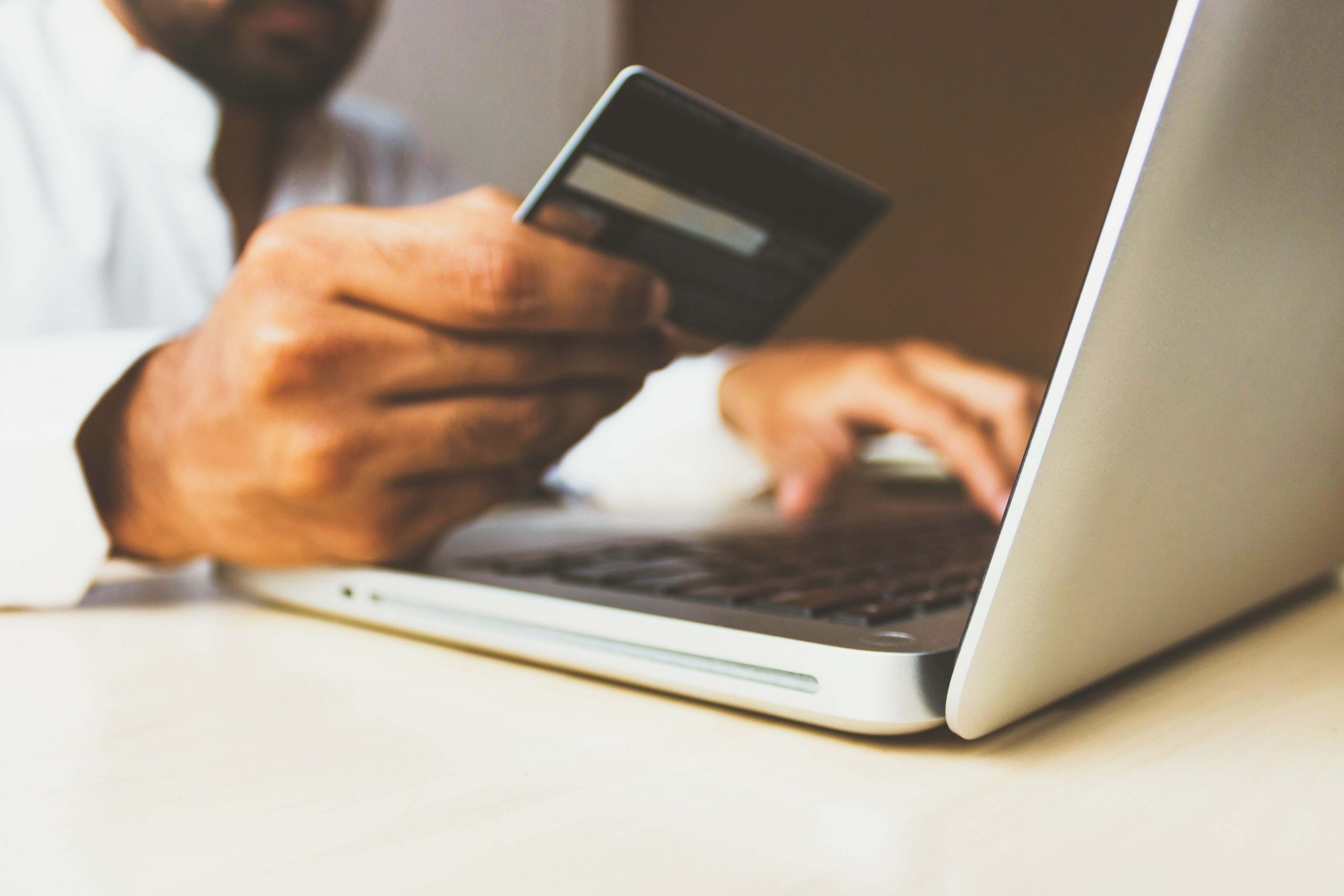 man using credit card to purchase used car online